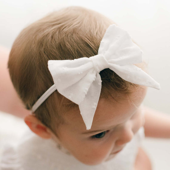 Baby girl wearing Christening Bow