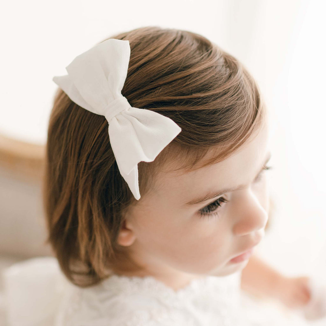 Close up detail of the Penelope silk bow on young toddler.