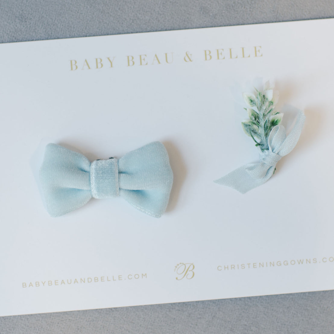 Flat lay photo of the Ezra Powder Blue Bow Tie and Boutineer