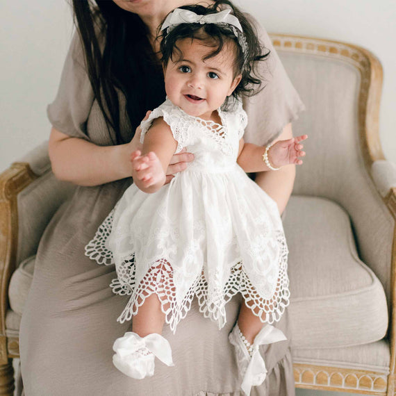 Baby wearing christening romper dress with scalloped edge cotton lace 