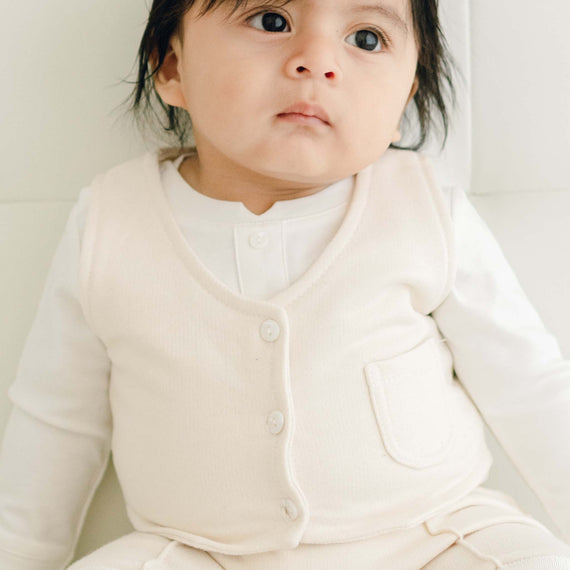Baby boy wearing the Braden vest with a white onesie underneath