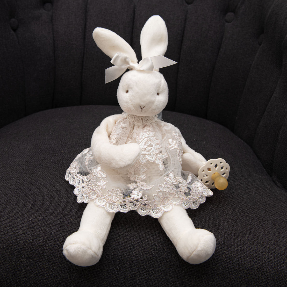 Product photo of the Plush Bunny Doll pacifier holder wearing lace from the Penelope christening dress.