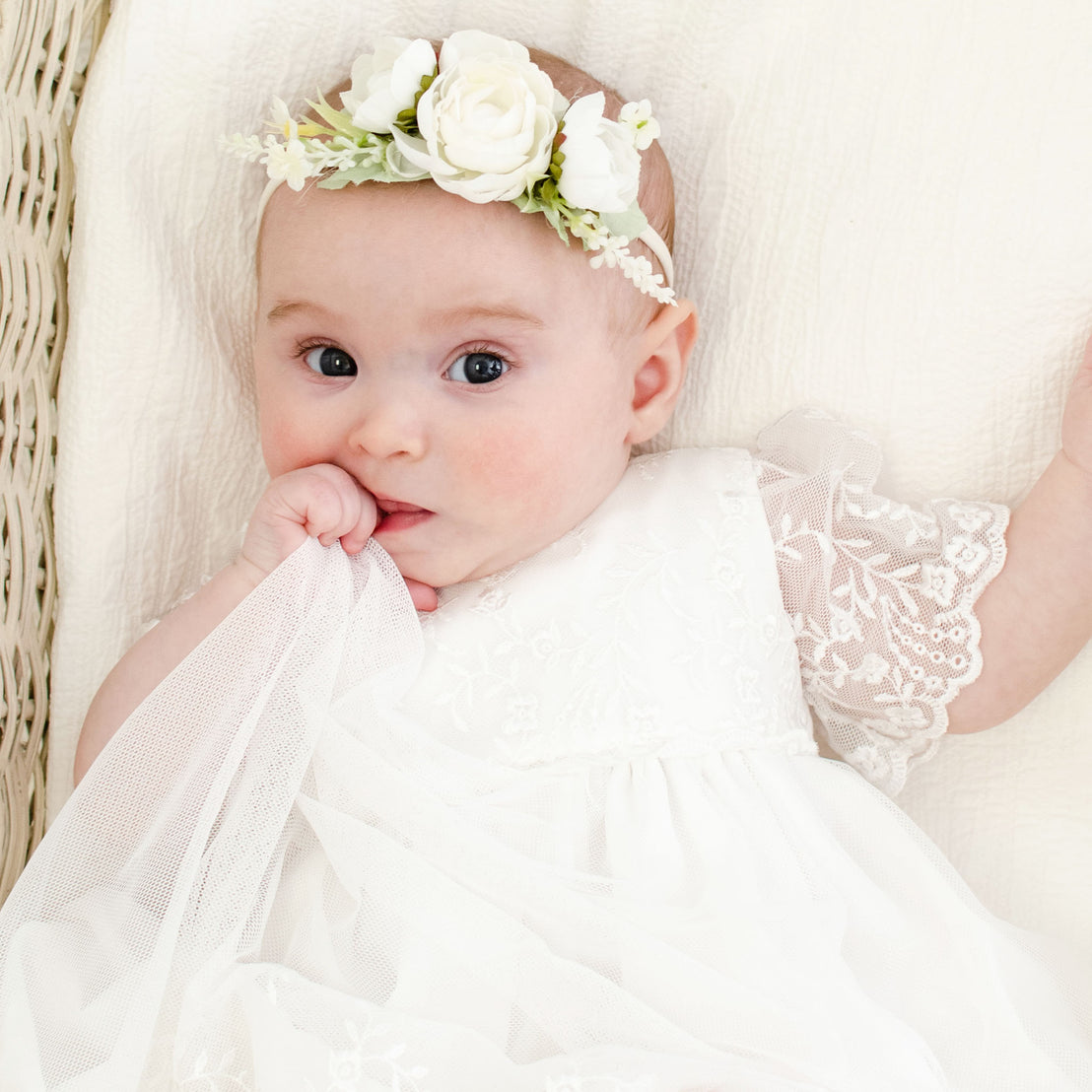 Flower headband on baby girl wearing Ella lace romper dress