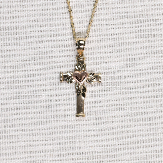 Solid gold cross charm with gold leaves and rose gold heart on chain