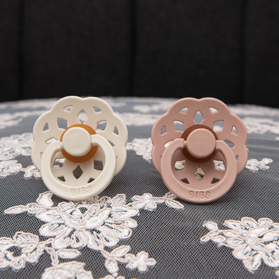 Pacifier set in ivory and blush.