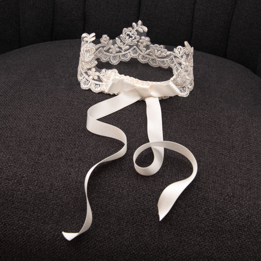 Product photo of lace crown on chair.