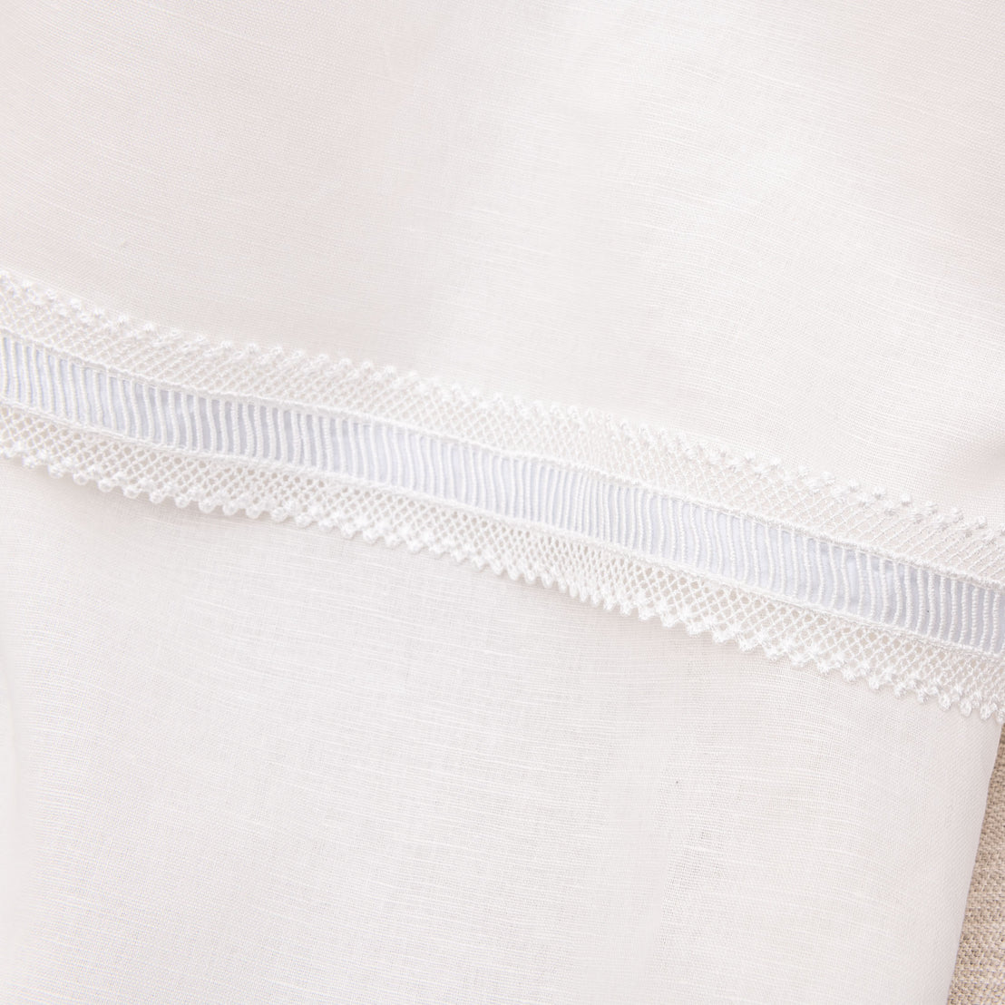 Close up detail of the hem on the Rowan boys baptism gown made of linen.