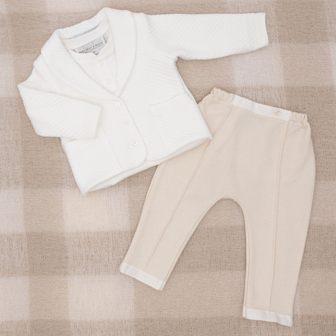Flat lay photo of the Braden 3-Piece Suit, including the jacket, pants, and onesie