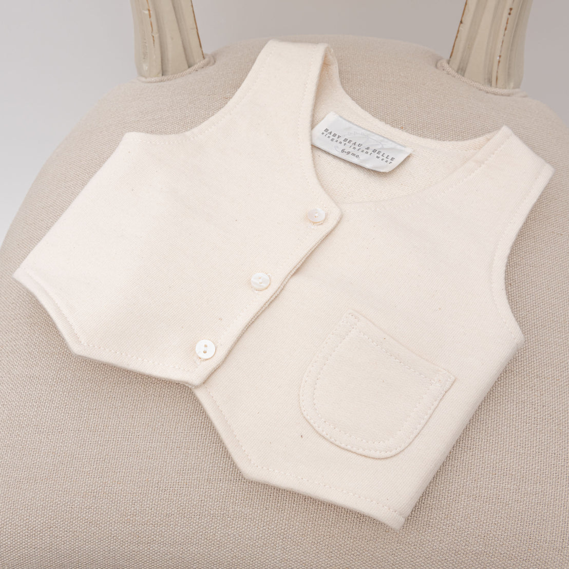 Flat lay photo of the Braden Vest made with an ivory french terry cotton