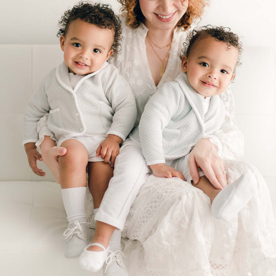 Two twin baby boys with their mother. They are wearing the Asher 3-Piece Suit, one in grey and the other in powder blue.
