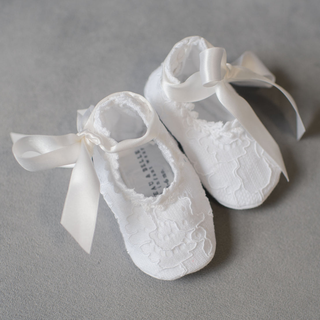 White lace and silk baby girl booties with ribbon tie