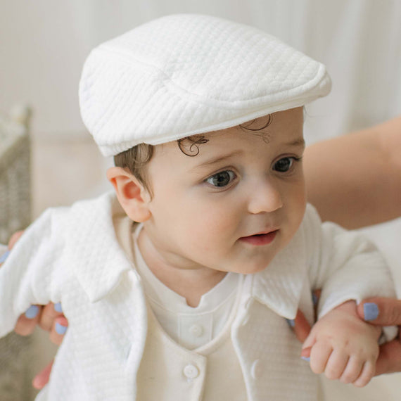 Baby boy in textured ivory cotton cap and jacket
