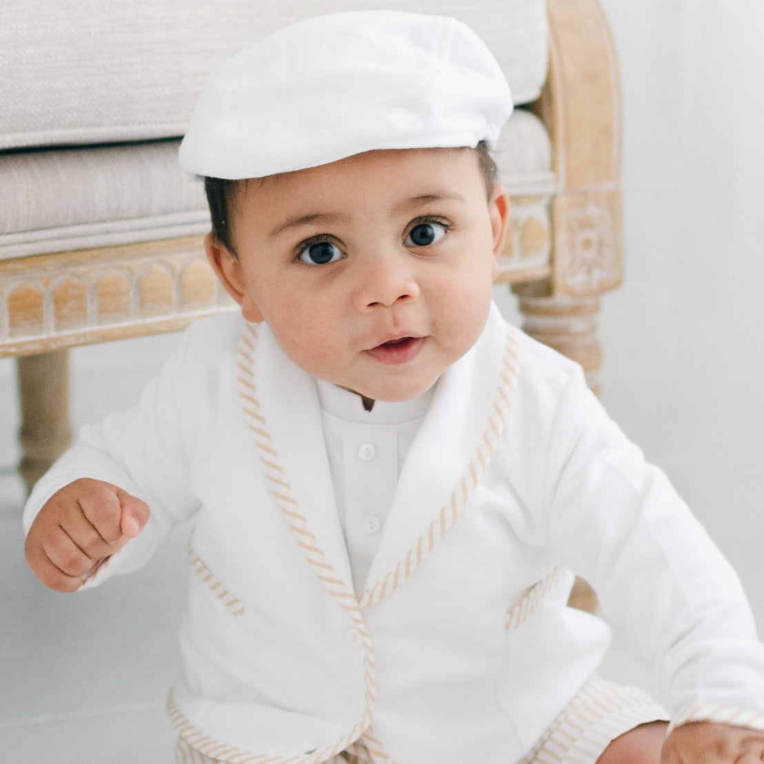 Baby boy wearing the Theodore 3-Piece Suit in tan.