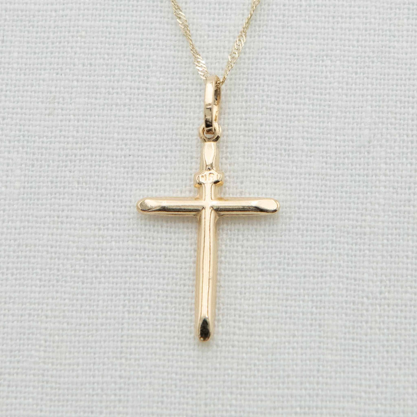 Round bar cross charm with INRI notation on chain