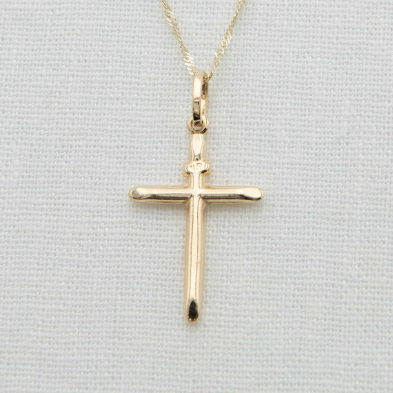 Round bar cross charm with INRI notation on chain