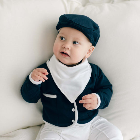 Baby boy wearing the Elliott Bandana Bib that matches the Elliott 3-Piece Suit. The bib is made from white French Terry cotton.