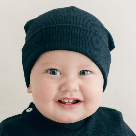 baby boy wearing the navy Ribbed Pima Beanie made from 100% ribbed textured Pima cotton.