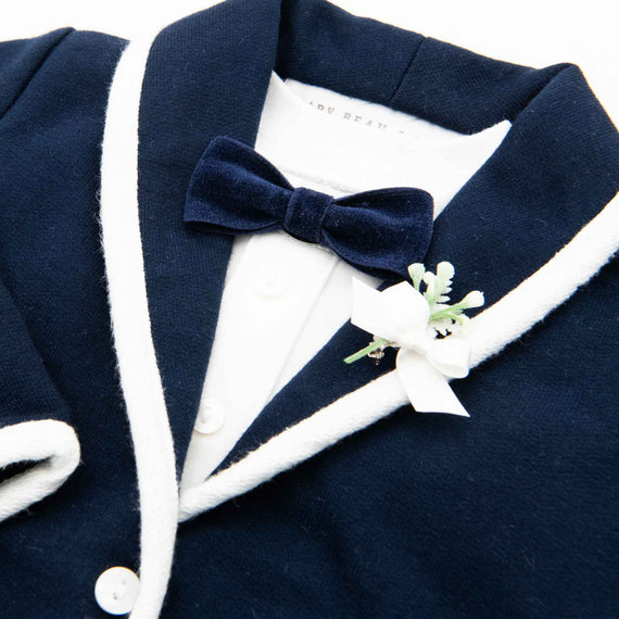 Navy blue velvet bow tie with navy blue jacket and white trim