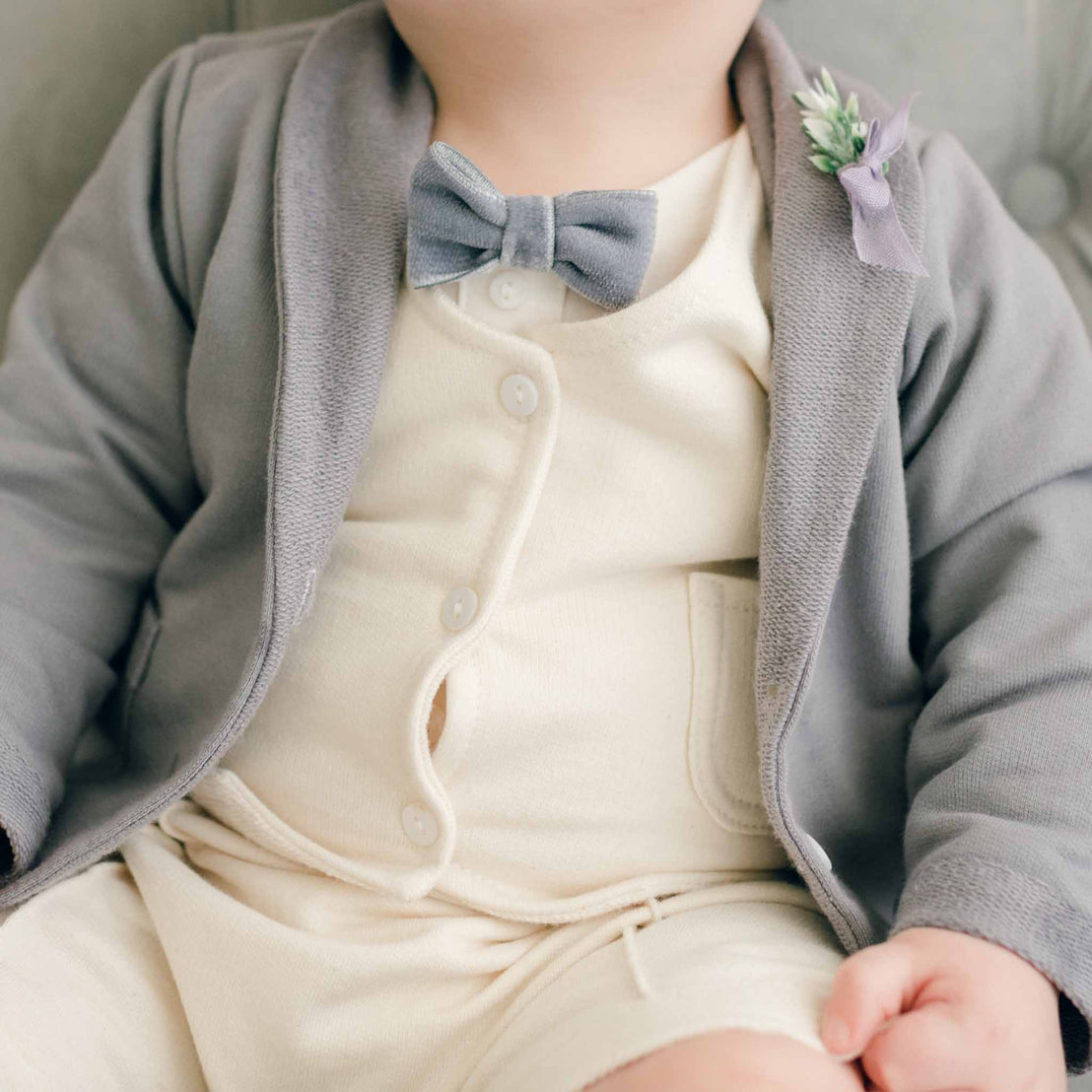 Baby boy wearing the Ezra French Terry Jacket with attached velvet bow tie and boutonniere