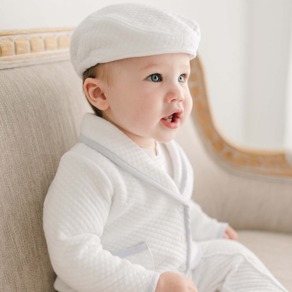 Side view of baby wearing the Harrison 3-Piece Pants Suit showcasing the luxuriously-soft jacket with fold over collar, functional pockets, and a light blue linen trim