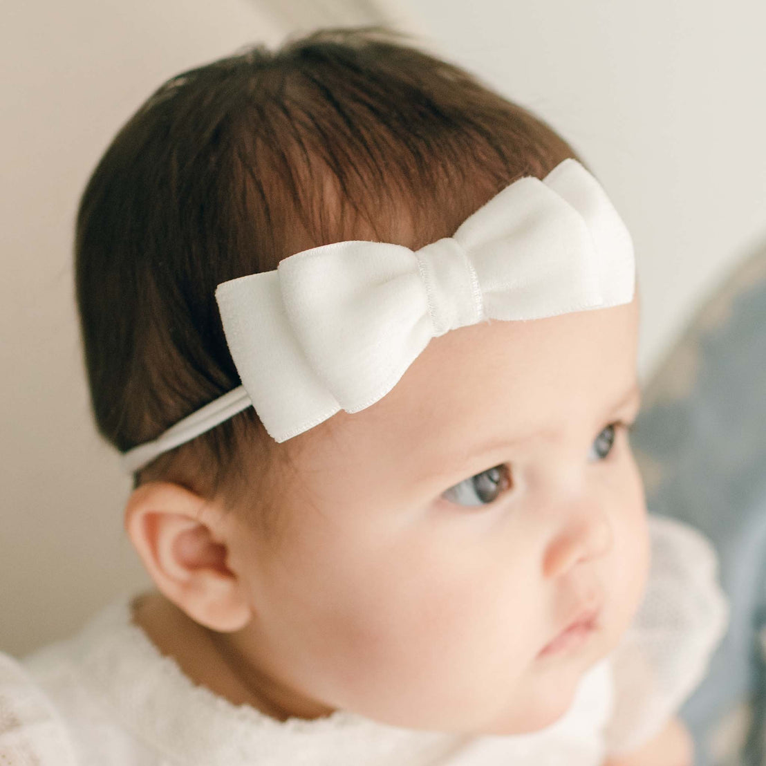 Baby Girl wearing the Ella bow headband made of velvet