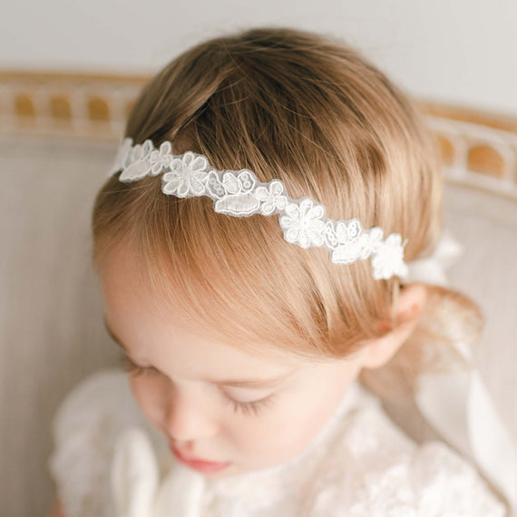 Floral lace headband pictured on girl.