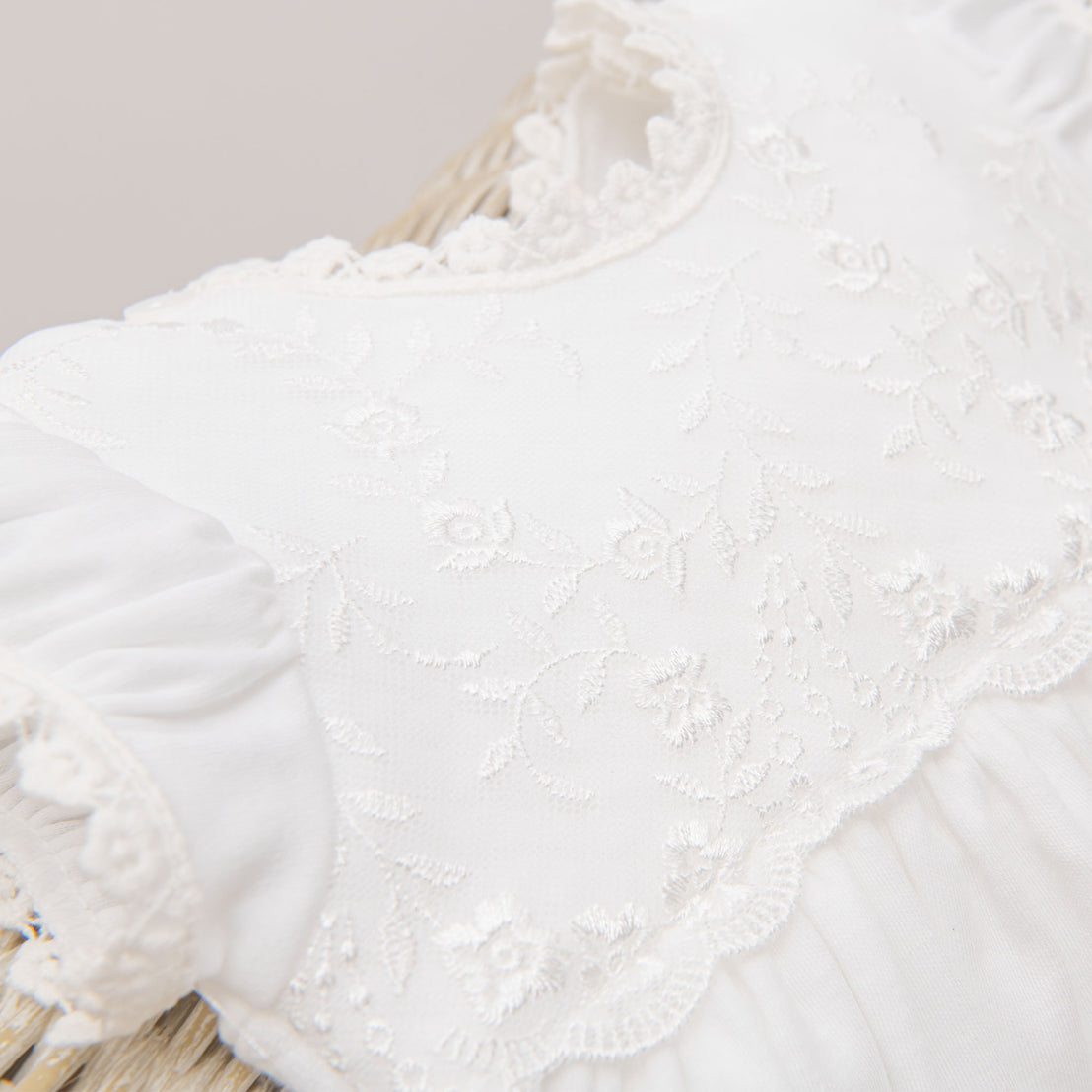 A flat lay photo highlighting the bodice of the Ella Layette gown.