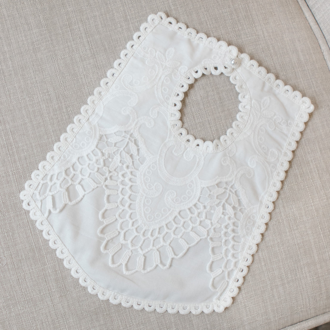 White lace bib on a beige fabric background