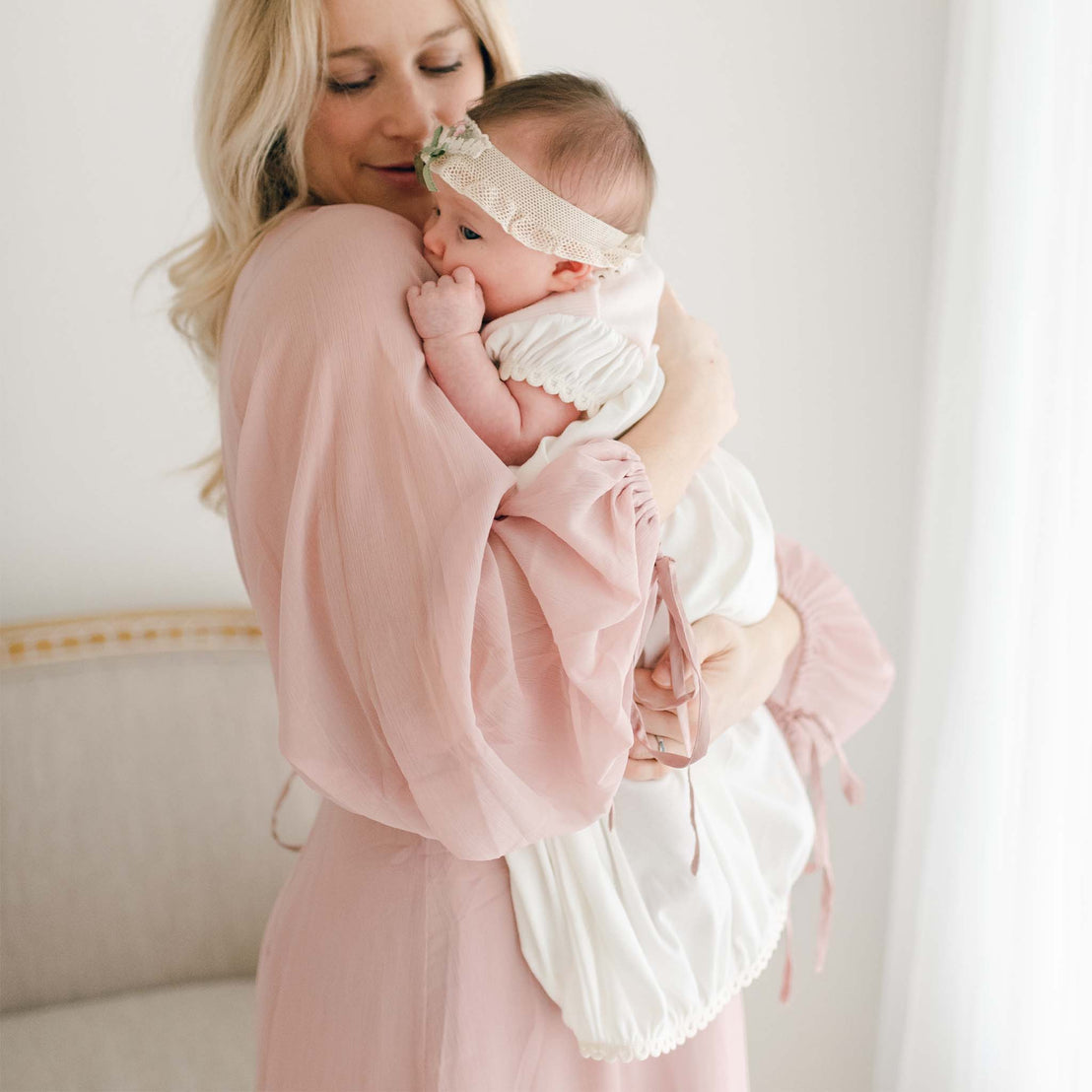 Mom hugging baby in Natalie gown
