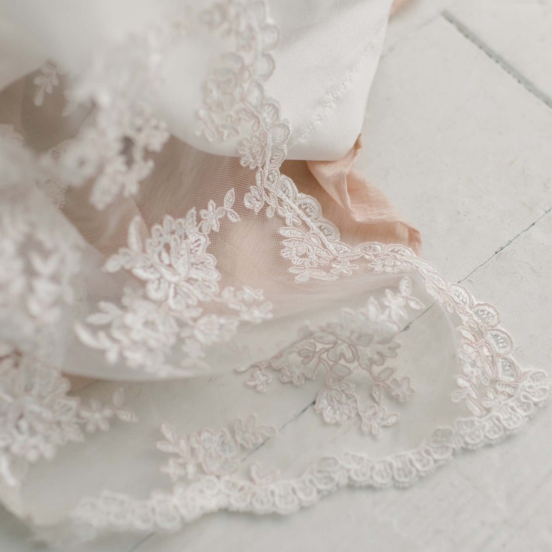 Ivory embroidered lace detail on traditional style baby gown for christening