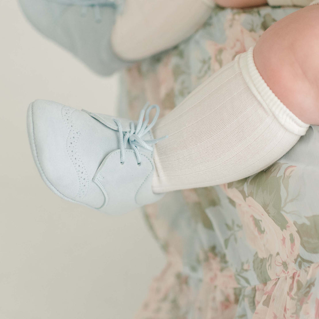 Baby wearing the sky blue Ezra Suede shoes