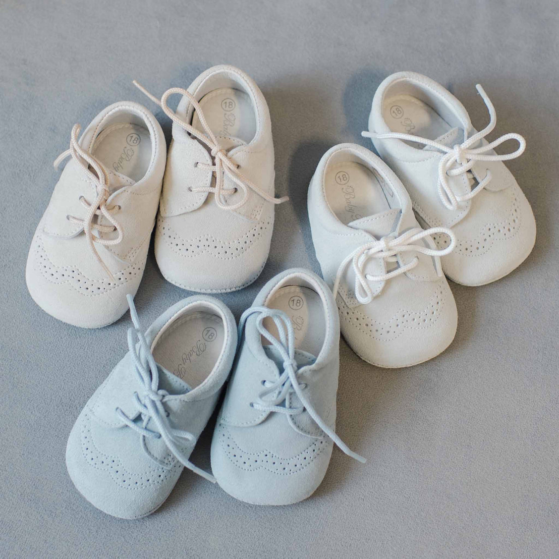 A photo of three pairs of Ezra Suede Shoes. These are available in three colors: tan, sky blue, and dove grey