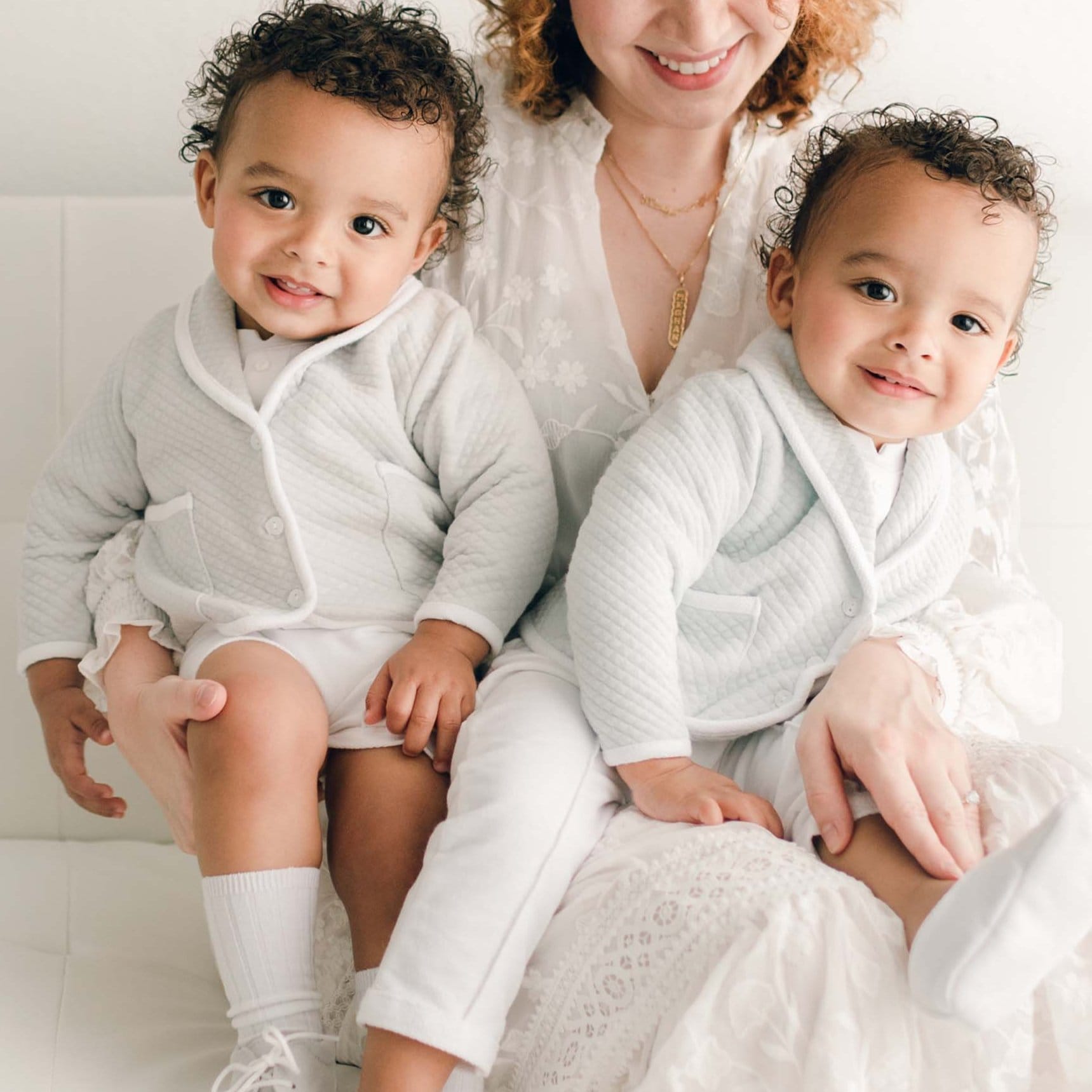 Two twin baby boys with their mother. They are wearing the Asher 3-Piece Suit, one in grey and the other in powder blue.