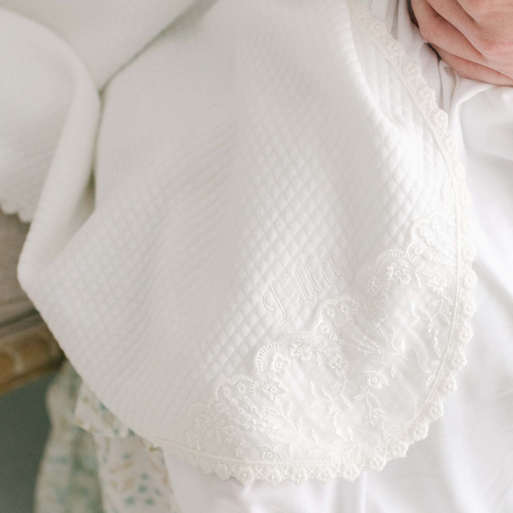 A photo showcasing the heirloom quality Ella personalized receiving blanket.