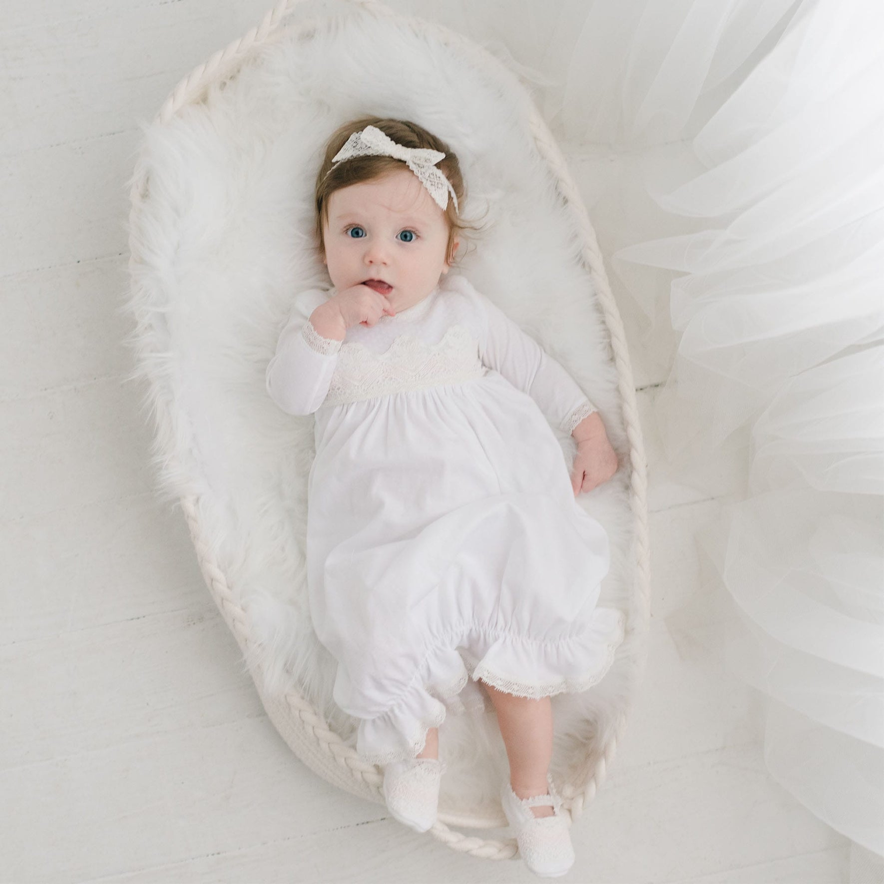 Hailey layette on baby in basket