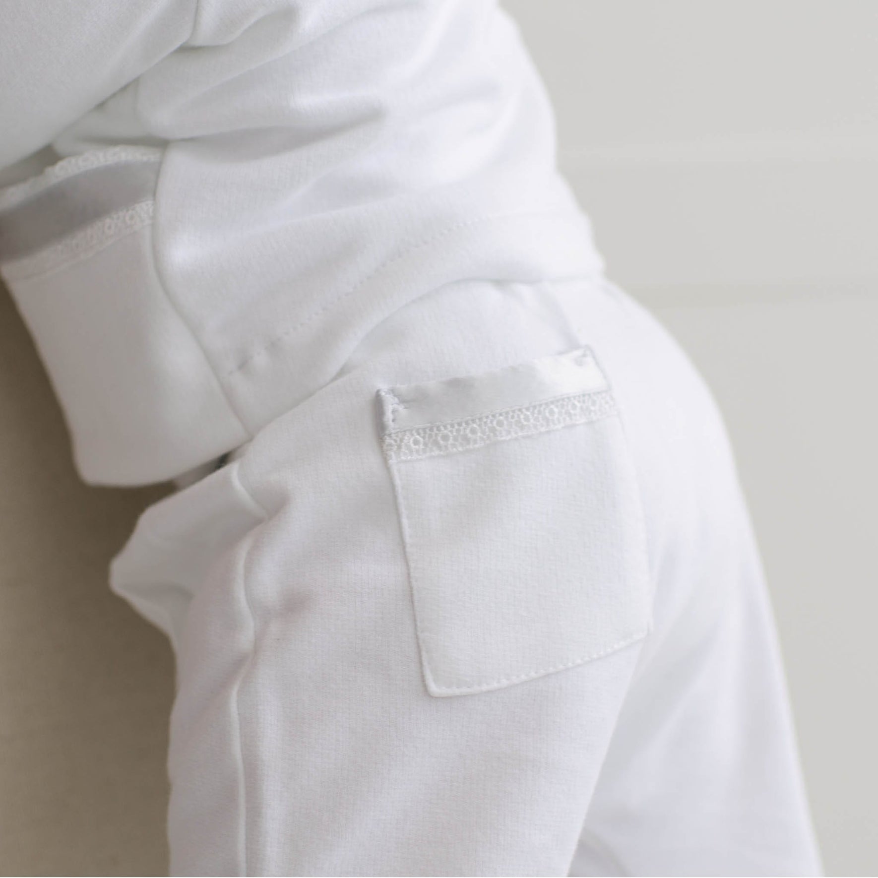 Close-up of the back of the Henry 3-Piece Suit Pant. The back pocket features Venice lace and blue silk ribbon detailing.