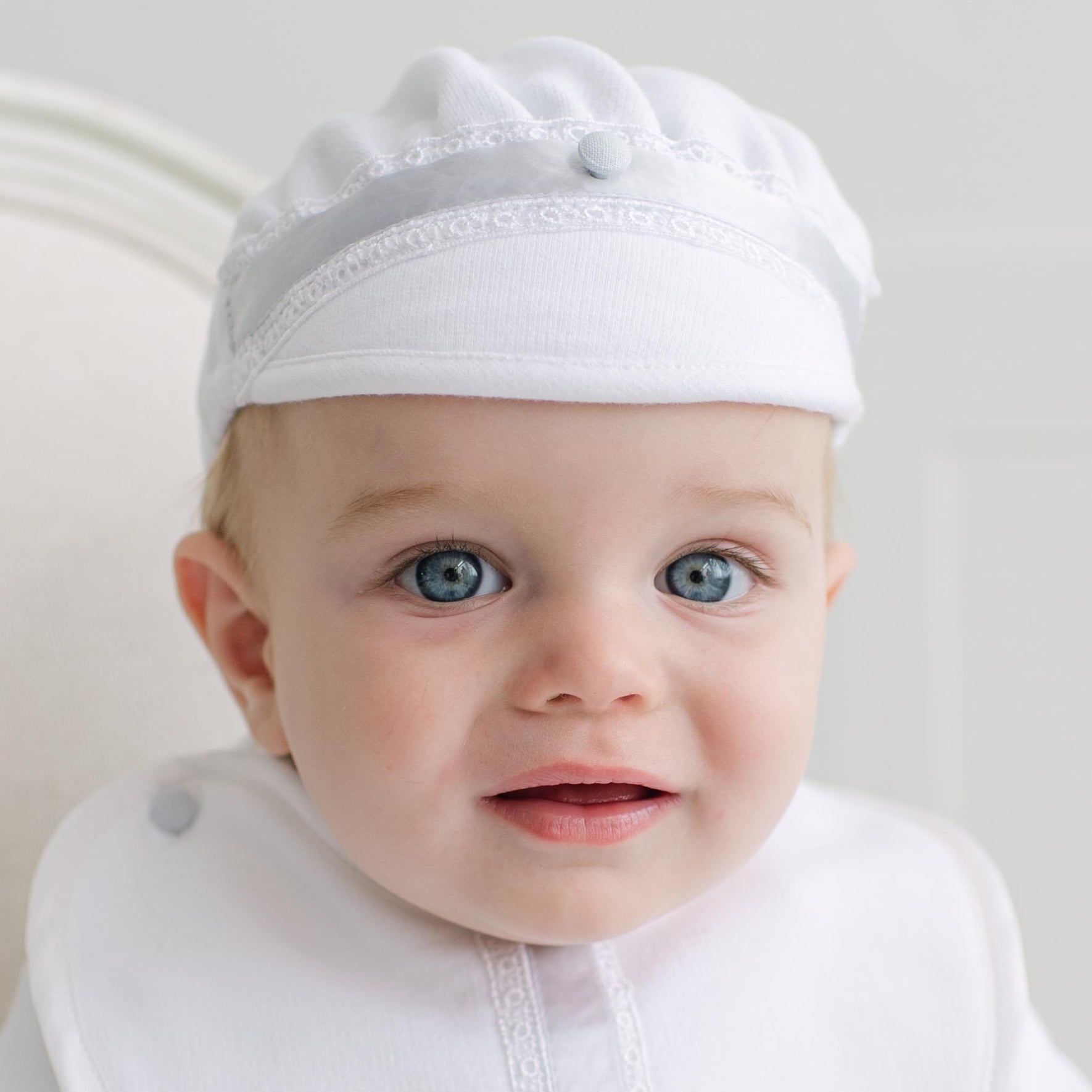 Baby wearing the Henry Brim Cap. Set against a plain background.