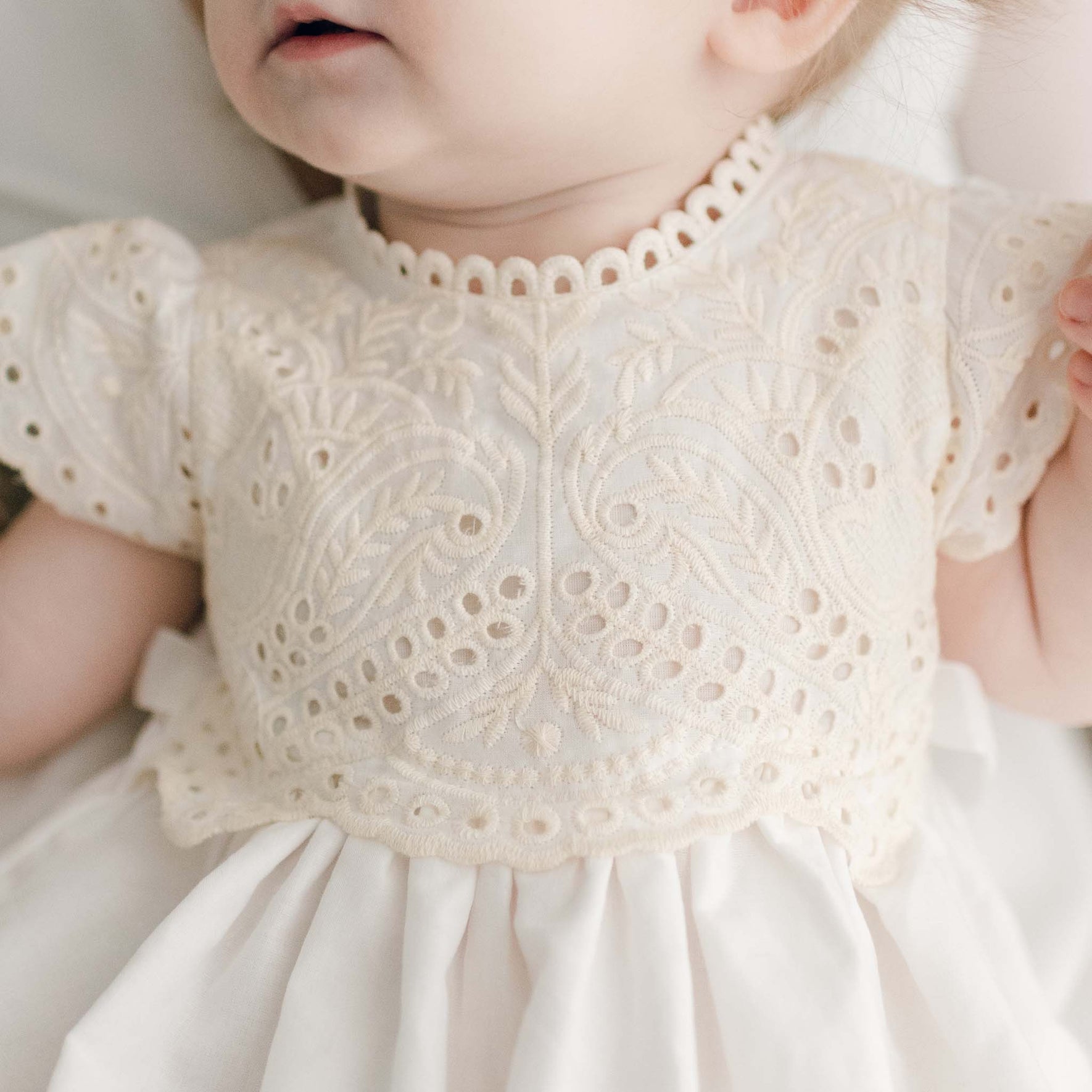 Close up of Ingrid Blessing Gown bodice showcasing the soft natural lace in scallop pattern that trims the neckline