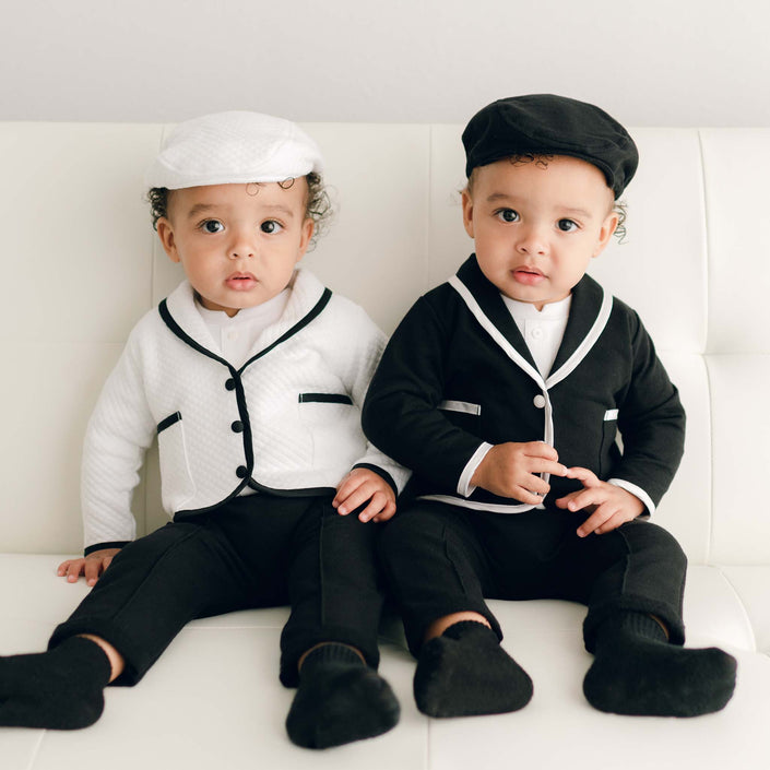 Two babies side by side wearing the James 3-Piece Suit in contrasting styles—one in white with black trim and the other in black with white trim.