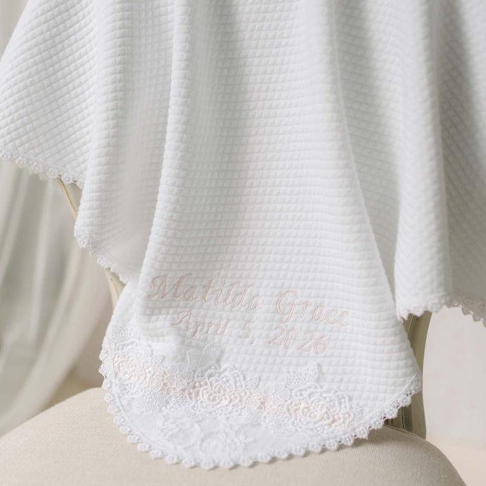 White textured blanket with lace trim and pink personalization name and date