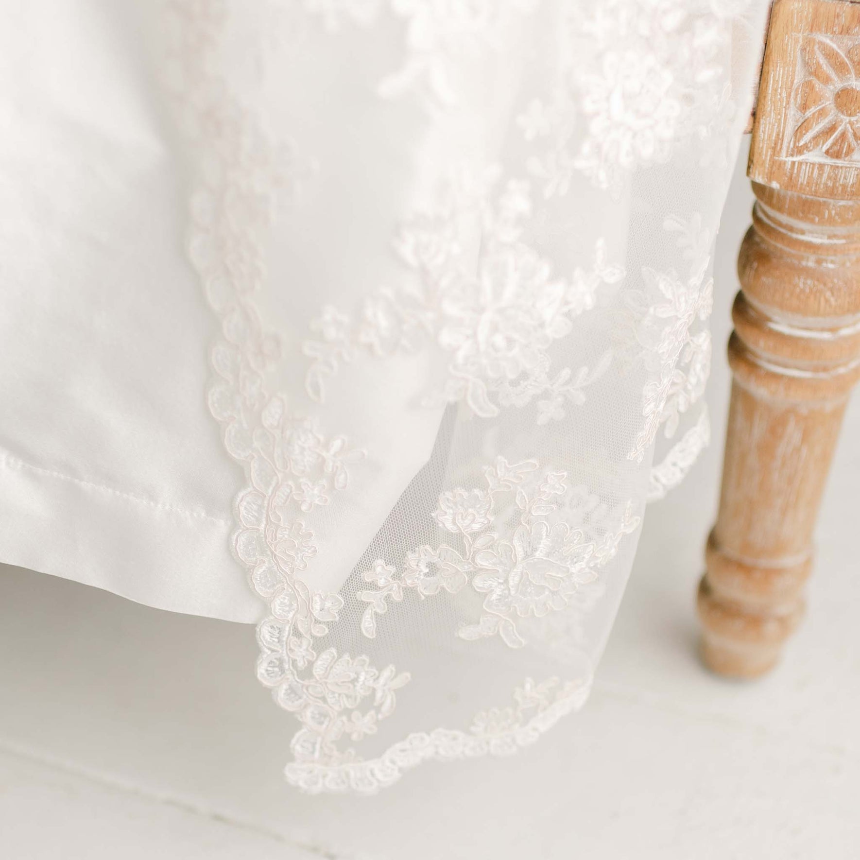 Photo of the hem of the Penelope silk and lace Christening Gown.