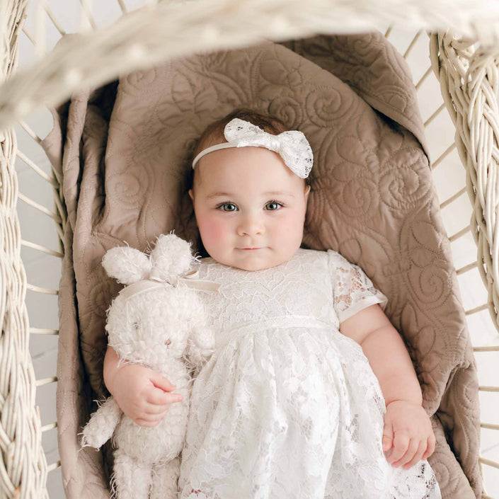 A plush shaggy Rose Bunny in a crib.