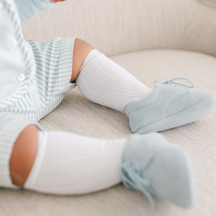 Baby boy wearing the Boys White Knee Socks made from cotton/nylon and spandex.