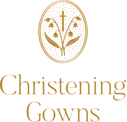 Logo with a gold emblem featuring lilies and a cross inside an oval, above the words "Christening Gowns" in gold text.