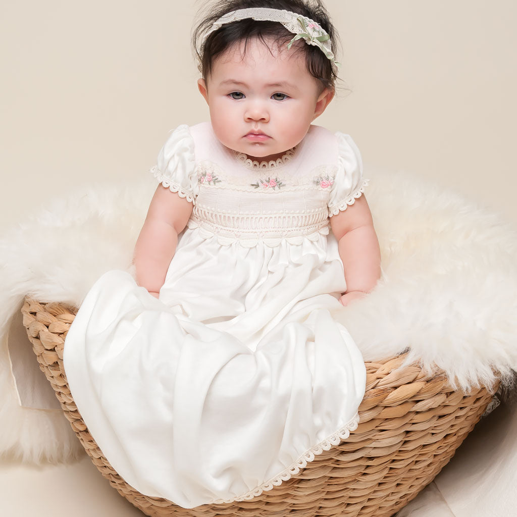Baby girl Natalie layette gown and headband sitting in basket