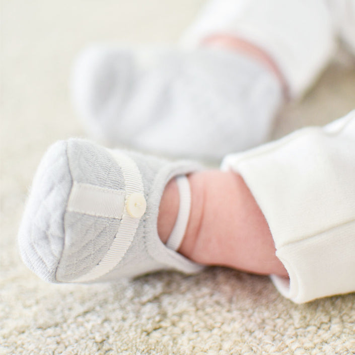 Grayson trim booties pictured on a baby boy.