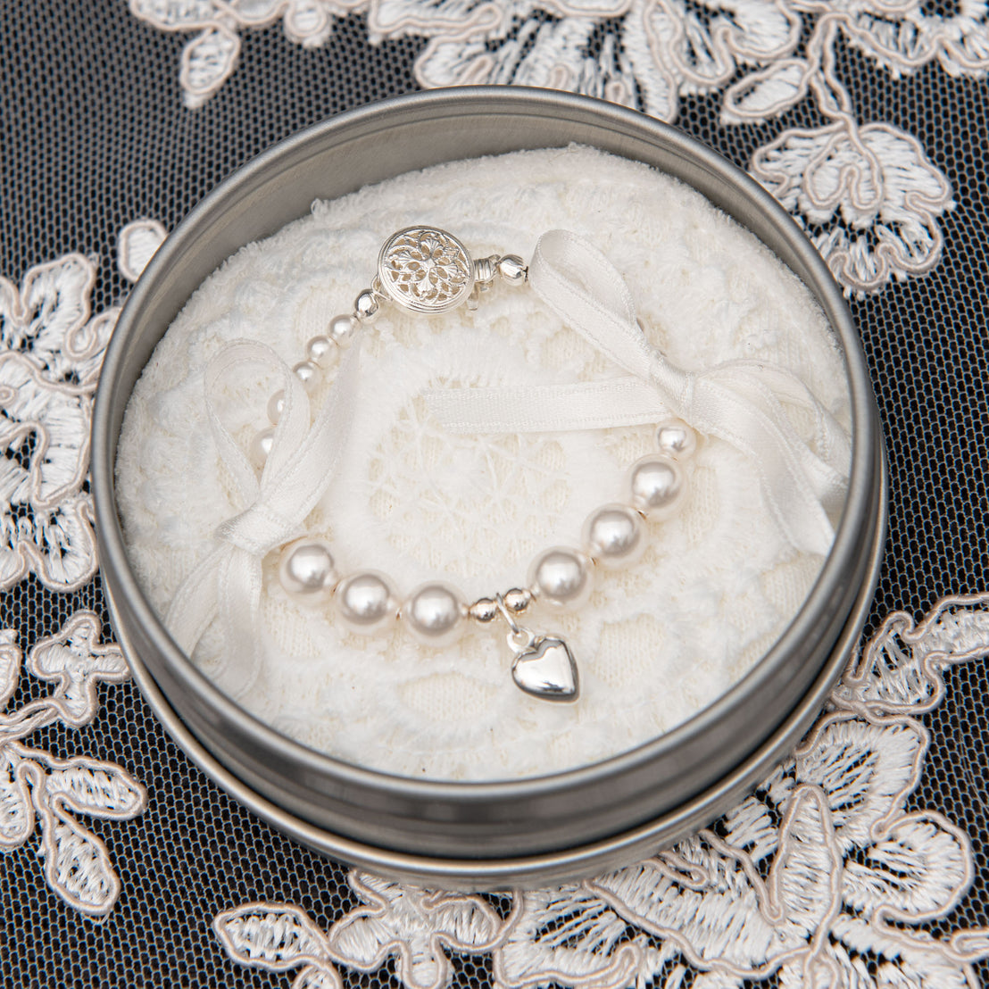 Photo of baby christening bracelet laying in jewelry case.