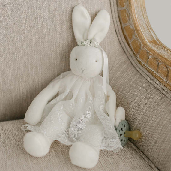 Plush baby rabbit doll wearing a small baptism dress