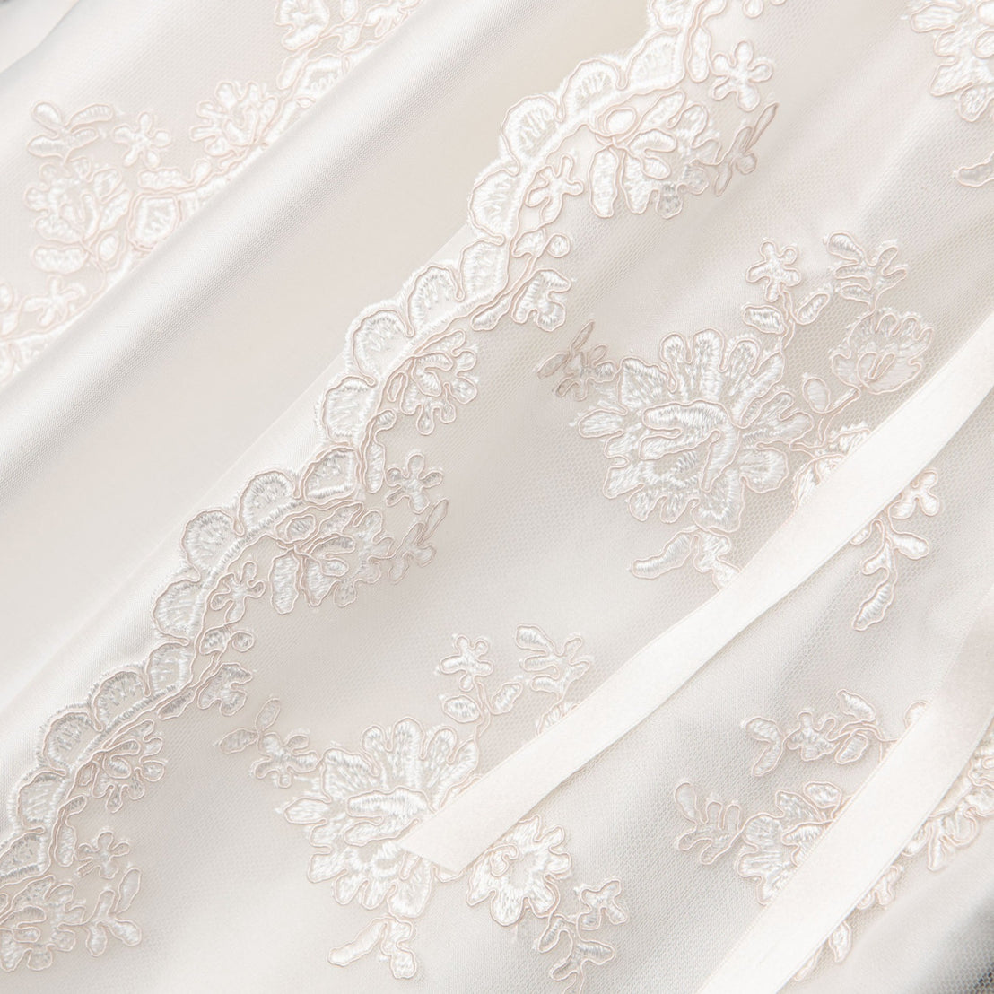 Detail of the floral lace and netting on the Penelope Christening Gown. 