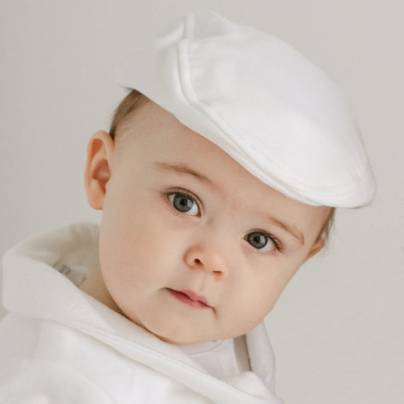 Baby boy wearing the Miles Newsboy Cap made from white french terry cotton